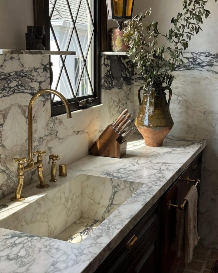 kitchen with marble slabs and gold fixtures